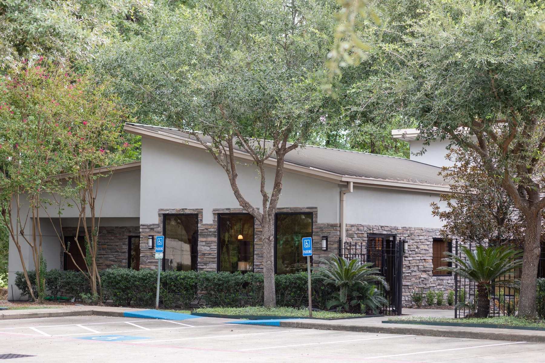 The Oak Hills Dentistry office on Louetta Road in Spring, Texas, shaded by mature trees